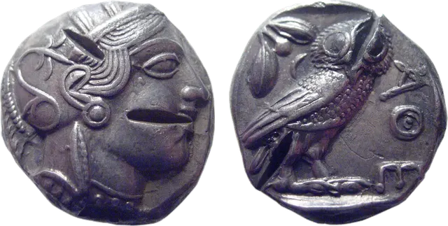 Both sides of an Athenian owl tetradrachm with several chisel test cuts made to check the silver