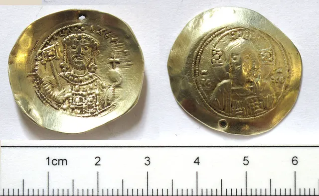 Pierced Byzantine gold coin of Michael VII found near Bedale in North Yorkshire, shown with a centimetre scale