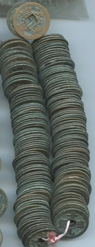 A string of 200 Northern Song dynasty bronze cash coins threaded on a cord through their square holes
