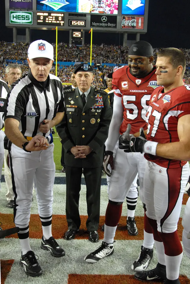 Referee showing the coin to the team captains at midfield before the coin toss at Super Bowl XLIII