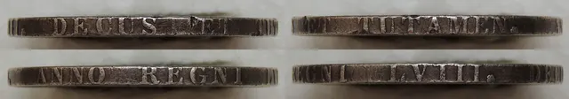 Close-up of a British crown's edge lettered "DECUS ET TUTAMEN"