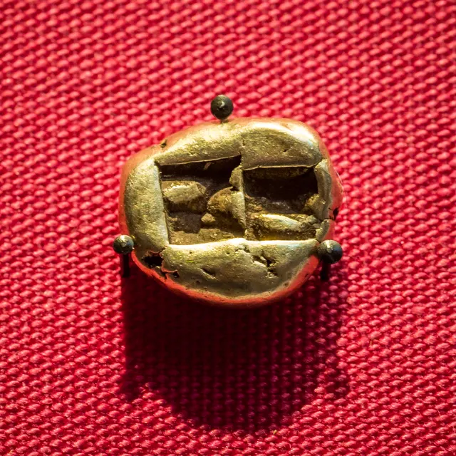 Electrum trite from Lydia, British Museum 1890,0804.8, showing the two square punch marks on its back