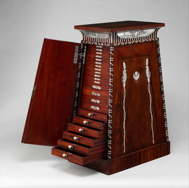 Early 19th-century French mahogany coin cabinet with silver mounts, its door open to show rows of small coin drawers