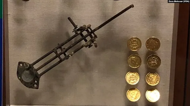 Counterfeiting equipment and eight fake $10 gold coins made from copper pennies, on display at the US Secret Service Museum