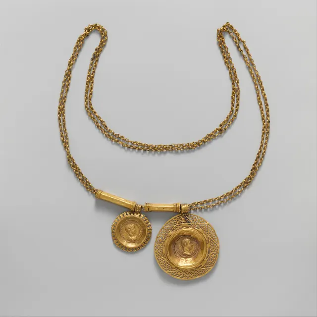 Roman gold double-strand necklace with two pendants, each a gold coin set in an ornate gold frame