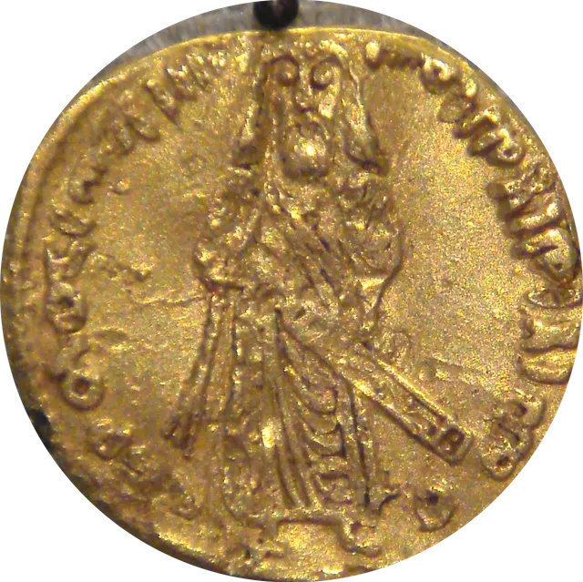 Gold "standing caliph" dinar of Abd al-Malik, about 695, showing a bearded, robed figure standing with a sword at his side