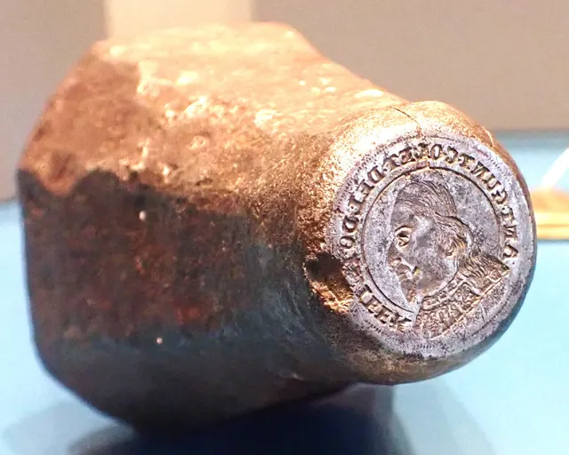 Worn iron coin die from 1664 with the design engraved into its face