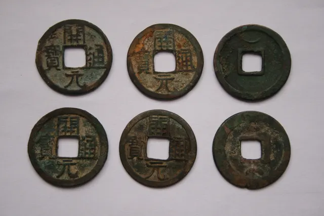 Six bronze Kaiyuan Tongbao cash coins from Tang China, each with a square hole