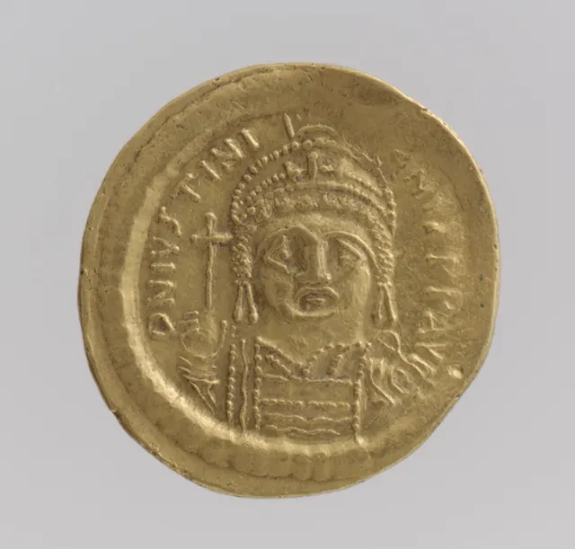 Gold solidus of Byzantine emperor Justinian I, facing bust holding a cross-topped globe
