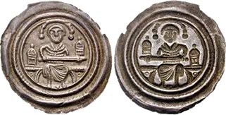 Silver bracteate of Bernhard of Saxony, Wittenberg, 1170–1212: a seated prince with a sword between towers, beside the hollow mirror image on the back