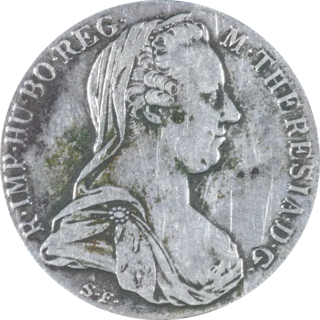 Silver Maria Theresa thaler showing the empress in a widow's veil and brooch, with the S.F. initials below the bust