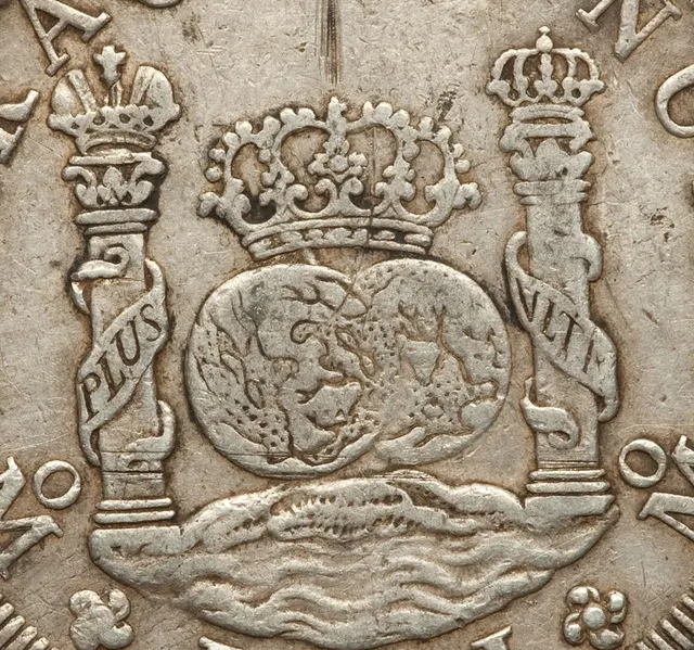 Close-up of the two globes and Pillars of Hercules on a Spanish milled dollar