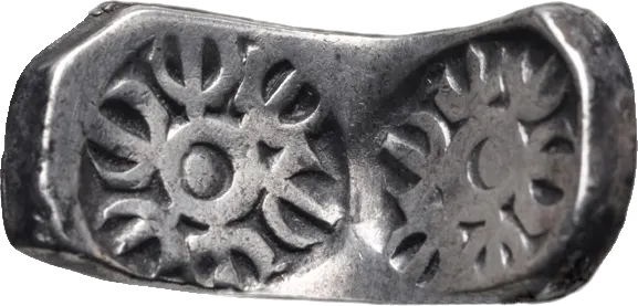 Curved silver bent bar from Gandhara stamped with a six-armed wheel symbol at each end