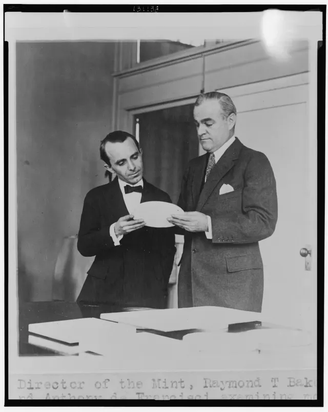 Mint Director Raymond T. Baker and sculptor Anthony de Francisci examining a plaster model of the Peace dollar in 1921