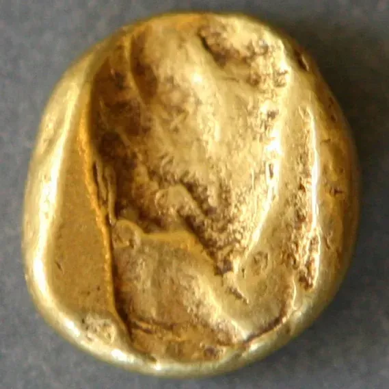 Back of the same gold daric: a plain oblong punch mark, no design