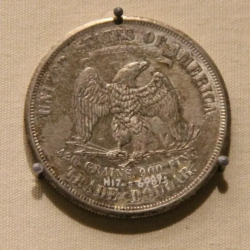A US trade dollar displayed among foreign silver coins used in China, at the National Museum of China