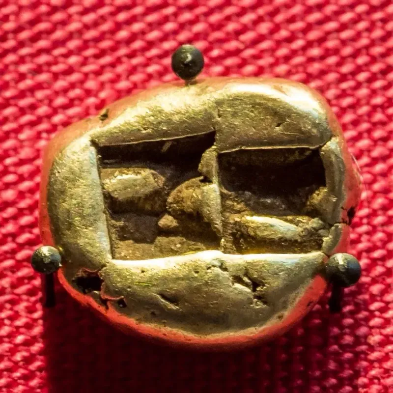 Back of a Lydian electrum trite in the British Museum, showing two square punch marks