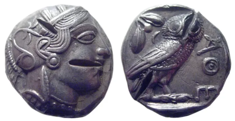 Both sides of an Athenian owl tetradrachm with several chisel test cuts made to check the silver